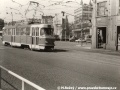 Vůz T3 ev.č.6446 vypravený na linku 24 míří od křižovatky u Hlávkova mostu k zastávce před Negrelliho viaduktem, v pravé části fotografie vykukuje tehdy ještě sídlo Dopravního podniku.... | 10.4.1976